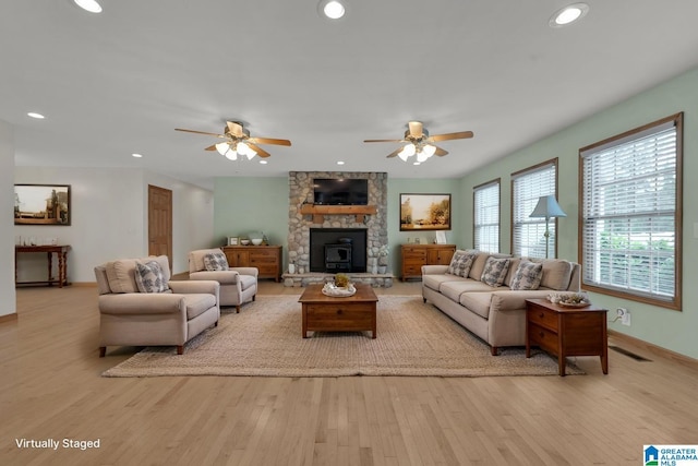 living area with a ceiling fan, recessed lighting, and wood finished floors