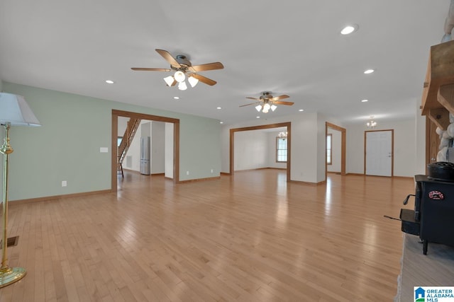 unfurnished living room with a ceiling fan, recessed lighting, light wood-style flooring, and visible vents
