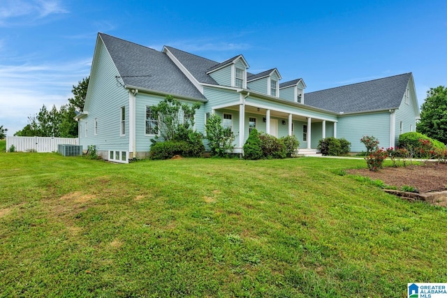cape cod home with fence, a shingled roof, a porch, and a front yard