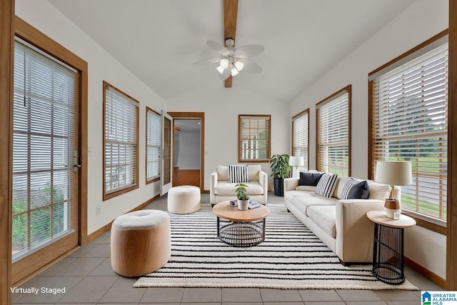 living room featuring vaulted ceiling with beams, baseboards, and a healthy amount of sunlight