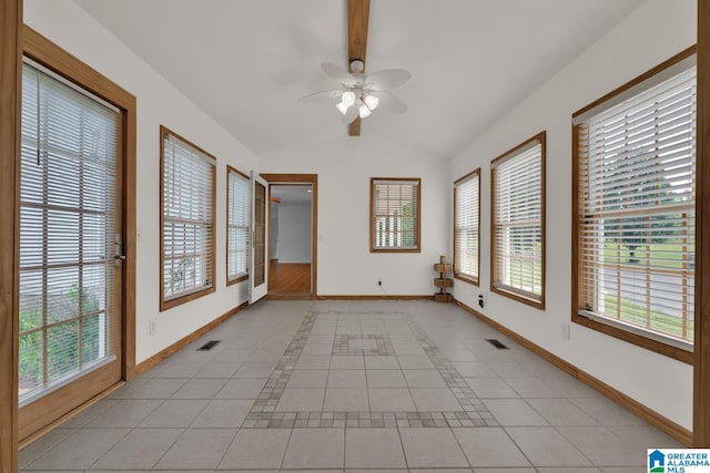 spare room with a ceiling fan, baseboards, visible vents, and vaulted ceiling