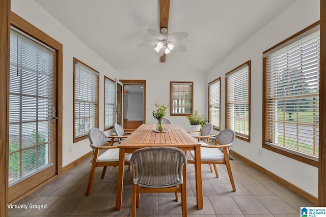 dining area with a ceiling fan, baseboards, and lofted ceiling