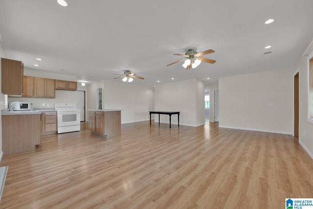 unfurnished living room with visible vents, baseboards, recessed lighting, a ceiling fan, and light wood finished floors