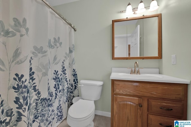 bathroom featuring vanity, toilet, baseboards, a shower with shower curtain, and tile patterned floors