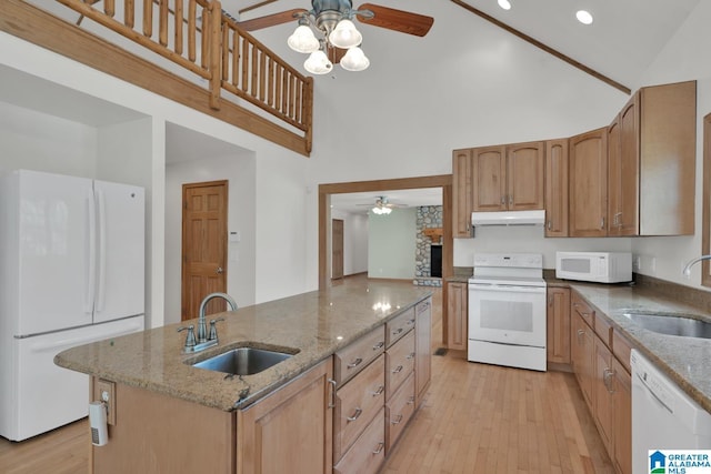 kitchen with white appliances, ceiling fan, a sink, and high vaulted ceiling