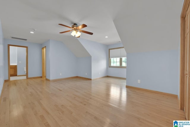 additional living space with visible vents, a ceiling fan, light wood-style floors, and baseboards