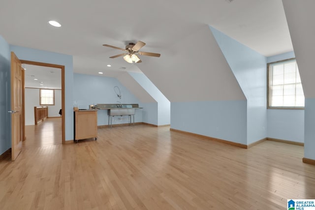 bonus room featuring ceiling fan, baseboards, lofted ceiling, light wood-style floors, and recessed lighting