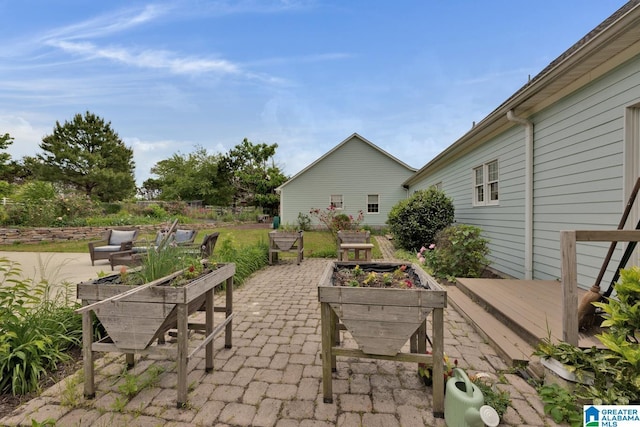 view of patio / terrace featuring a deck and a vegetable garden
