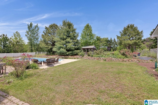 view of yard with a fenced in pool, fence private yard, a gazebo, and a patio area