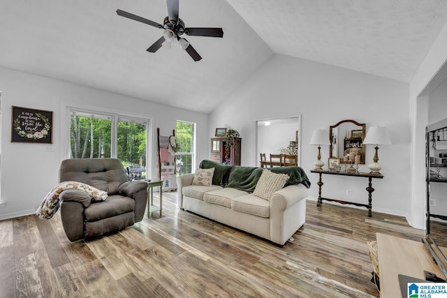 1522 Bower Dr SE, Cullman, AL 35055 - living room featuring baseboards, ceiling fan, high vaulted ceiling, and wood finished floors
