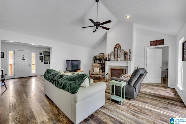 1522 Bower Dr SE, Cullman, AL 35055 - living room with wood finished floors, a fireplace, baseboards, ceiling fan, and high vaulted ceiling