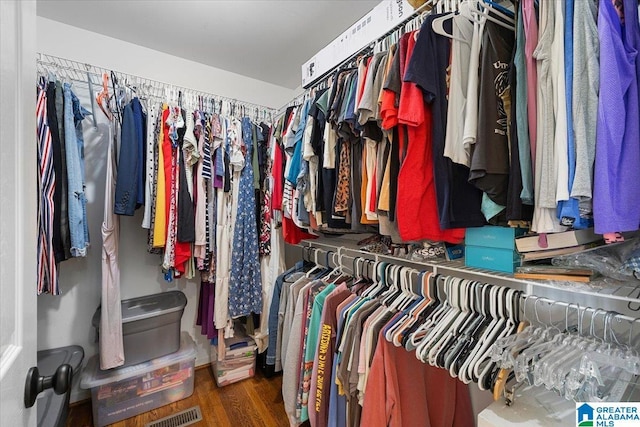 spacious closet featuring visible vents and wood finished floors