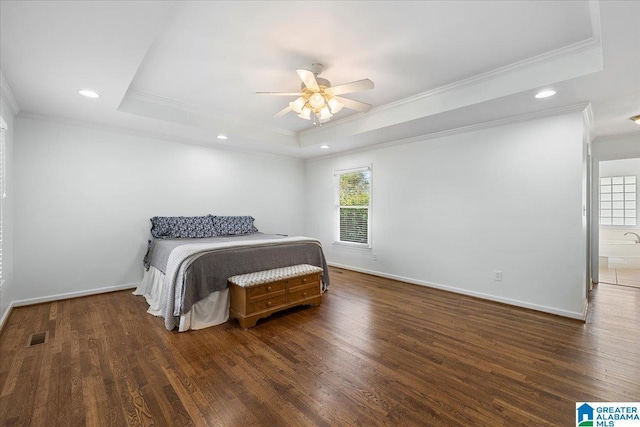 bedroom with ornamental molding, a raised ceiling, and multiple windows