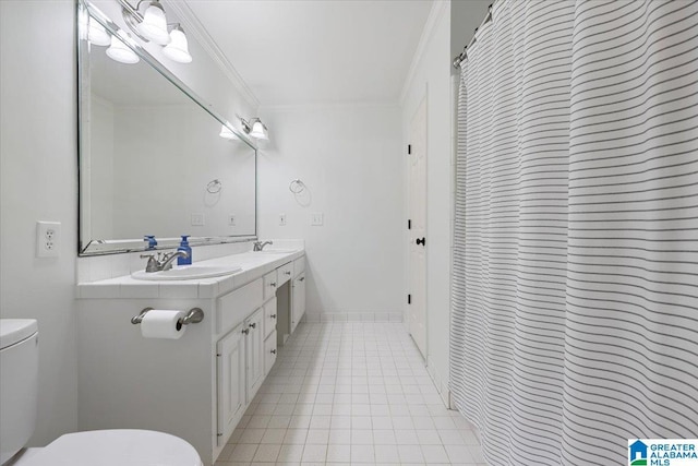 full bath featuring tile patterned flooring, double vanity, ornamental molding, toilet, and a sink