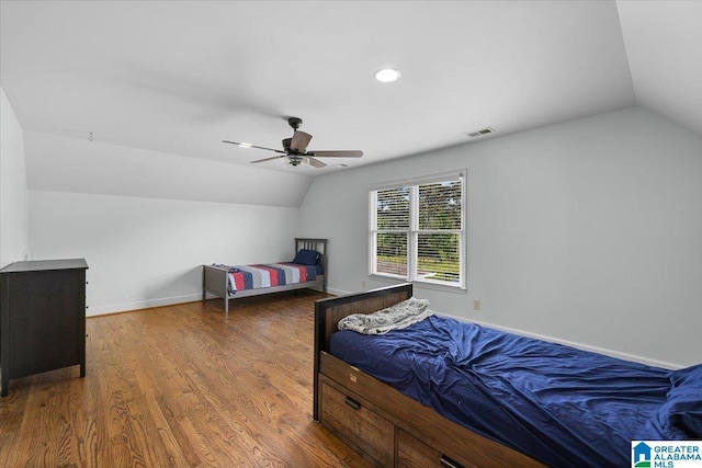 bedroom featuring baseboards, a ceiling fan, wood finished floors, and vaulted ceiling