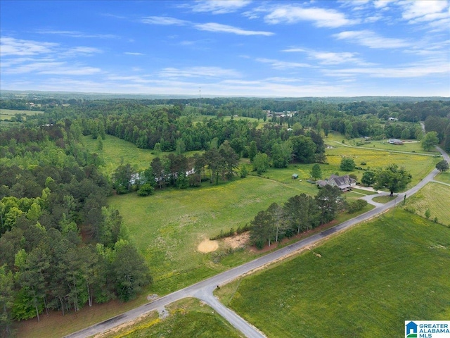 birds eye view of property featuring a view of trees
