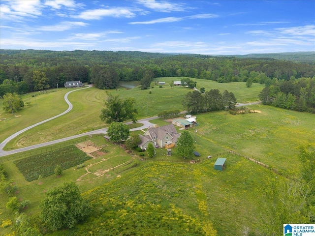 birds eye view of property featuring a rural view and a wooded view