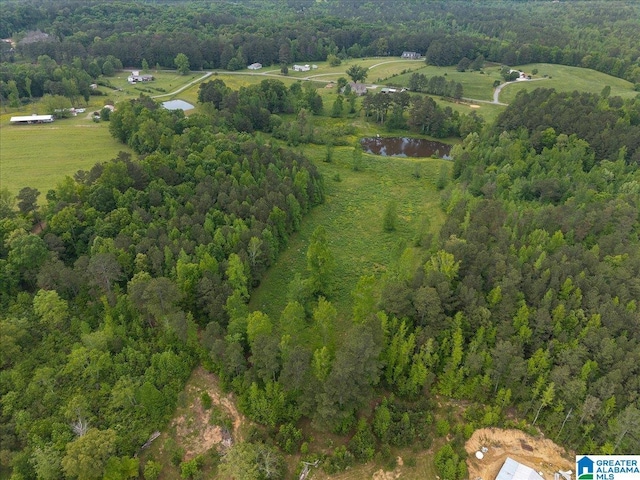 drone / aerial view featuring a forest view