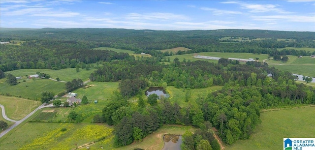 birds eye view of property with a water view, a rural view, and a wooded view