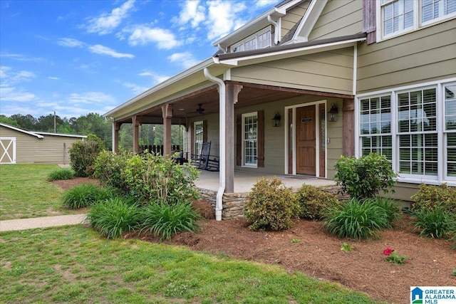 view of side of property with a lawn and a porch