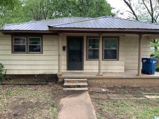 view of front facade featuring a porch and metal roof