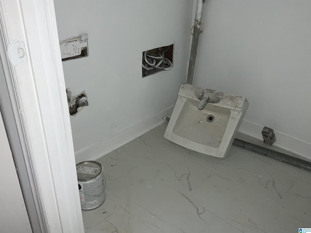 bathroom with a sink and marble finish floor
