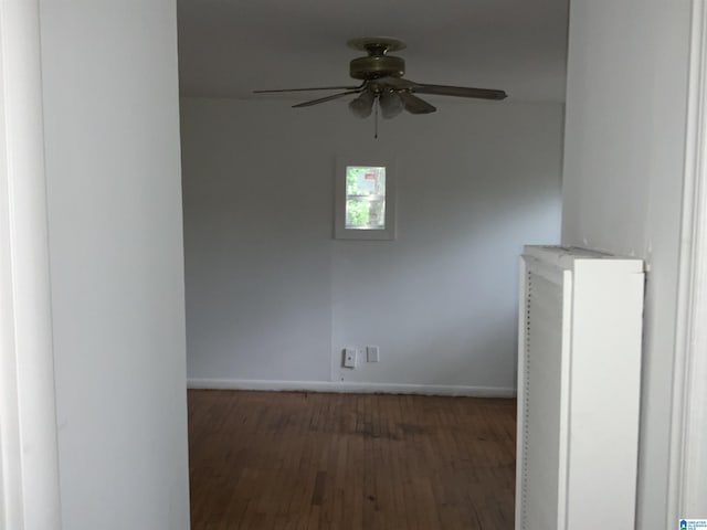 unfurnished room with baseboards, ceiling fan, and wood finished floors