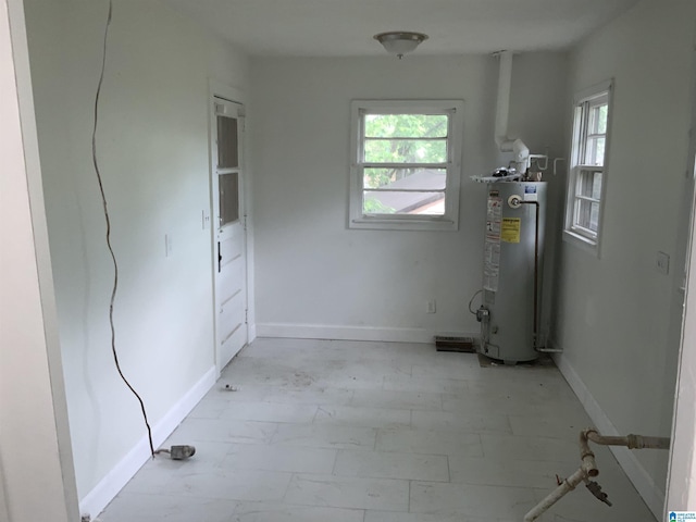 interior space featuring baseboards and water heater