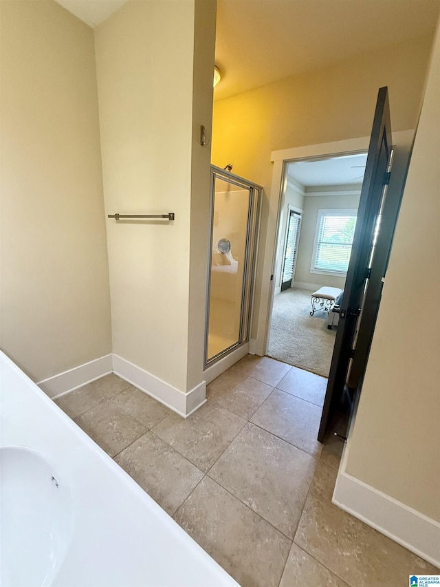 full bath with baseboards, a stall shower, and tile patterned floors
