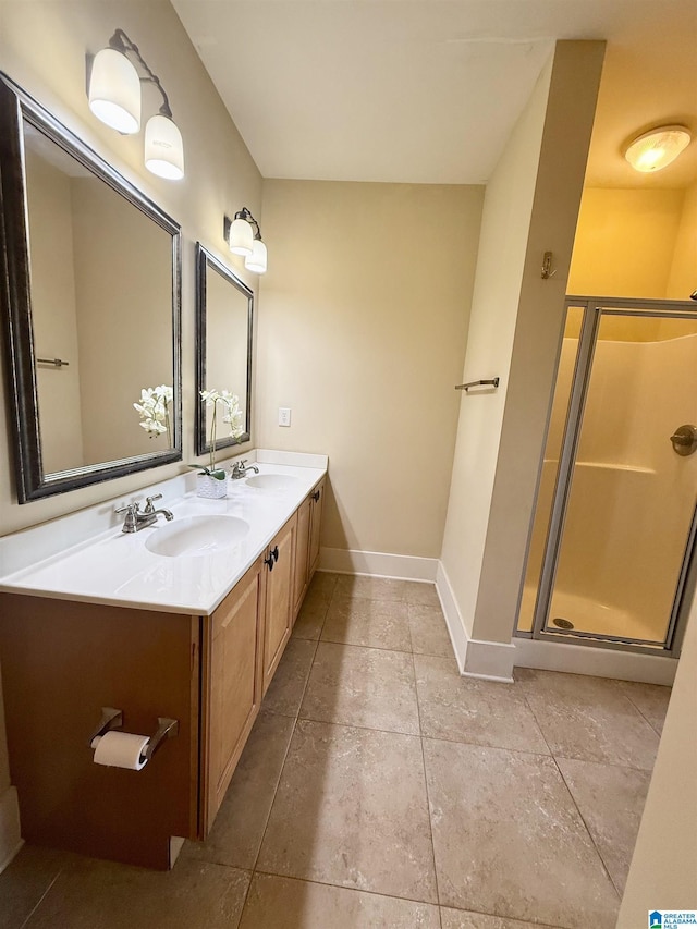 bathroom featuring baseboards, a stall shower, double vanity, and tile patterned flooring