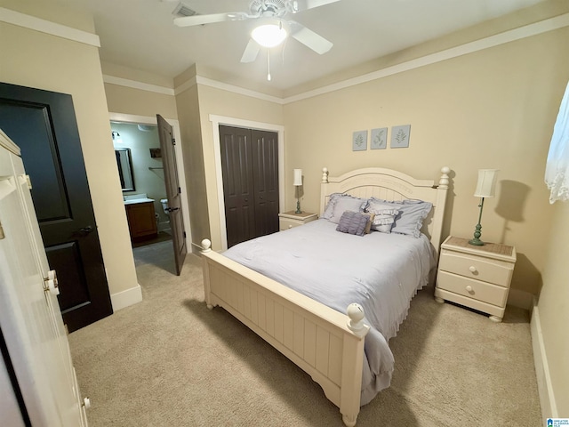 bedroom featuring light colored carpet, a closet, a ceiling fan, baseboards, and connected bathroom