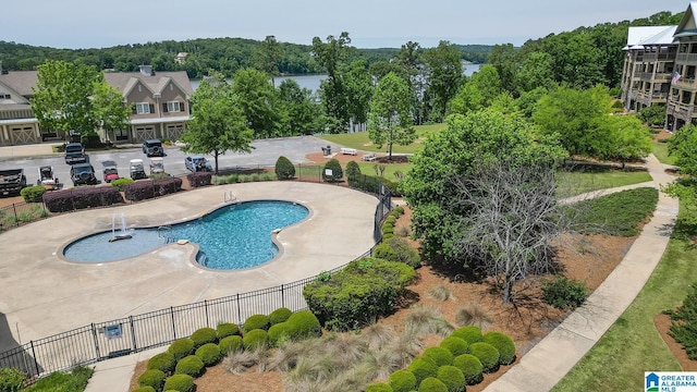 view of swimming pool featuring fence