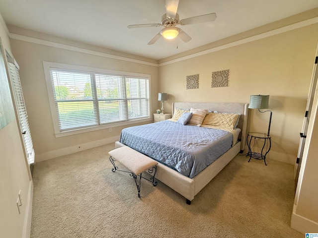 bedroom with carpet, ceiling fan, and baseboards