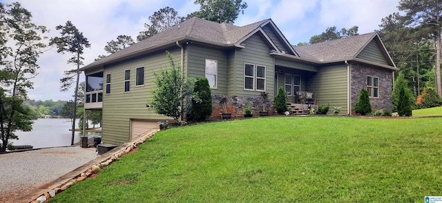 view of side of home featuring a lawn, an attached garage, driveway, and roof with shingles