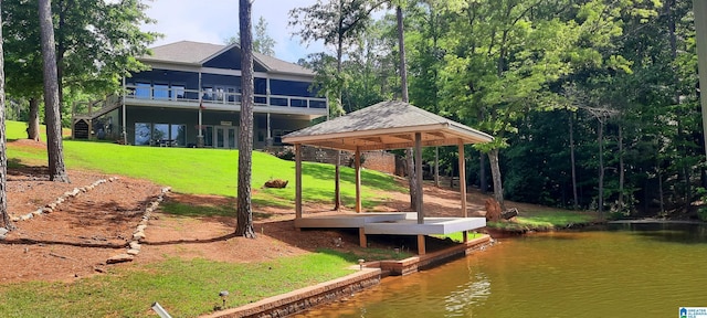 dock area featuring a lawn and a water view