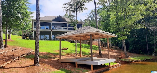 exterior space featuring a gazebo, a water view, and a yard