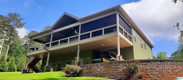 rear view of house featuring a yard, stairway, and a deck