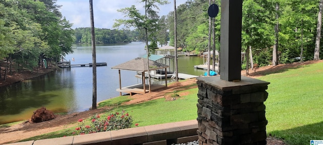 view of dock featuring a yard and a water view