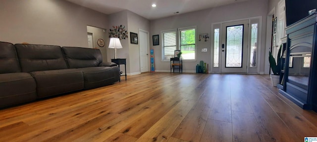 living area with recessed lighting, baseboards, and hardwood / wood-style floors