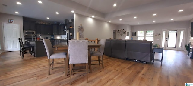 dining room with recessed lighting and light wood finished floors