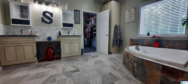 full bath featuring vanity, a walk in closet, and a bath