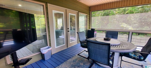 sunroom / solarium with outdoor dining area and french doors