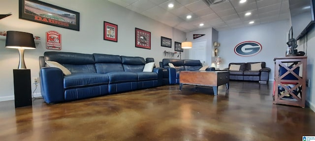 living area featuring finished concrete floors, recessed lighting, baseboards, and a paneled ceiling