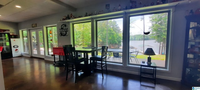 dining space with french doors, recessed lighting, baseboards, and a water view