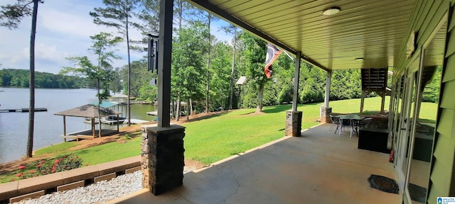 view of patio / terrace featuring a water view, boat lift, and a boat dock