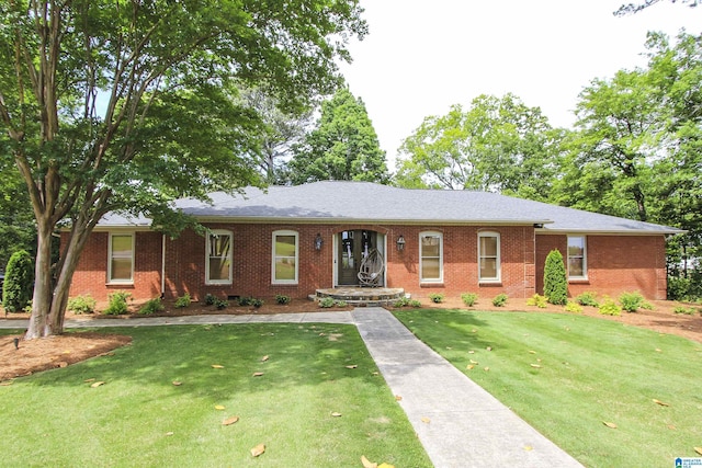 ranch-style house featuring a front yard and brick siding