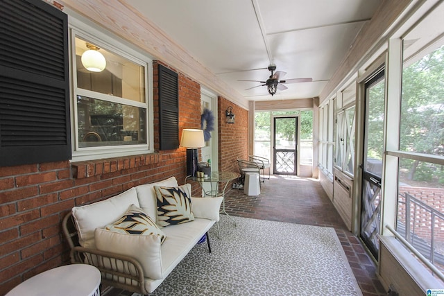 sunroom / solarium featuring a ceiling fan