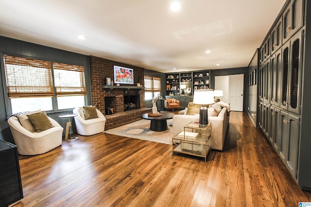 living area with a fireplace, recessed lighting, and dark wood-type flooring