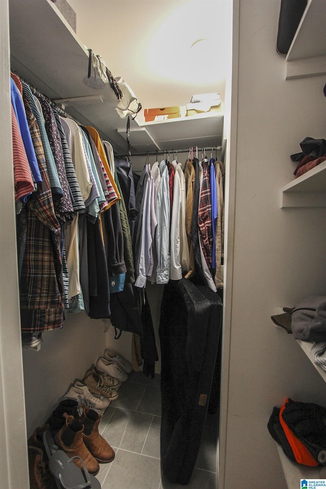 spacious closet with tile patterned floors
