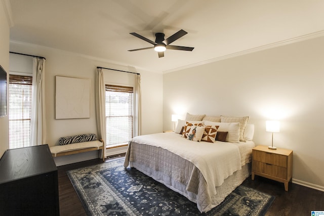 bedroom with a ceiling fan, baseboards, dark wood-style floors, and ornamental molding